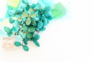 Creative image of emerald and green Hydrangea flowers on artistic ink background. Top view with copy space