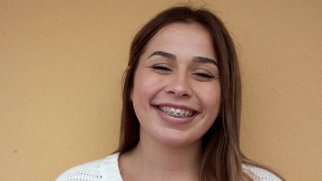 Young girl smiling on camera with dental brace - Generation z and happiness concept 