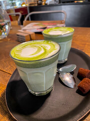 Two glass cups of matcha latte drink