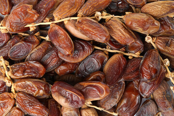 Sweet dried dates on branches as background, top view. Healthy snack