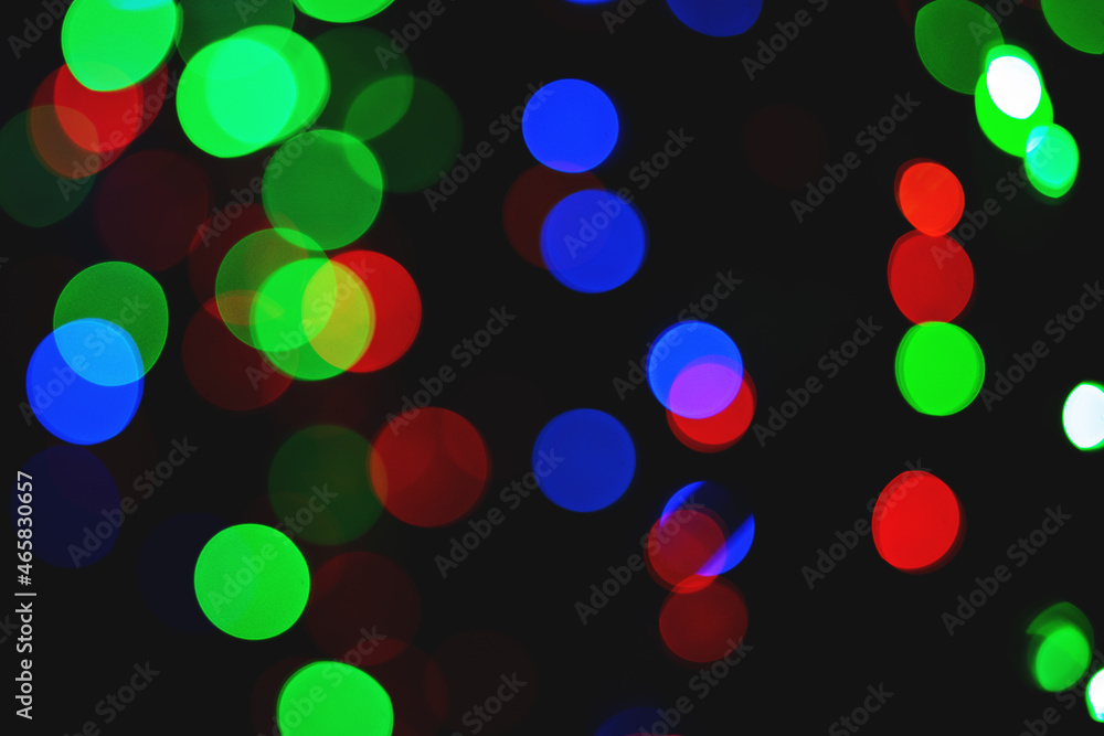 Poster bright bokeh on a black background. background random composition. defocused image