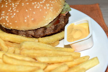 Triple meaty delicious hamburger with nice fries