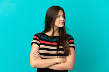 Fototapeta premium Teenager Brazilian girl over isolated blue background looking to the side