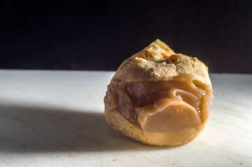 pão de queijo, cheese buns stuffed with dulce de leche in a white container, coy space and selective focus