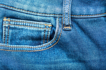 Fototapeta premium Jeans background. Denim fabric closeup. Textures of clothing fabric with fashion embroidery blue colors. Copy space for text. Fashion and Style.