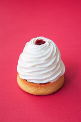 tartlet with whipped cream and cherry jam over the red
