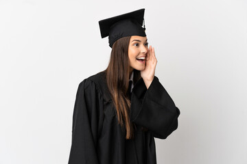 Teenager Brazilian university graduate over isolated white background shouting with mouth wide open to the side