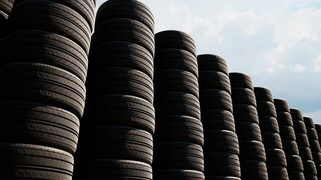 Stacks of car wheels. Black rubber tires. Tire store. Wheels changing.
