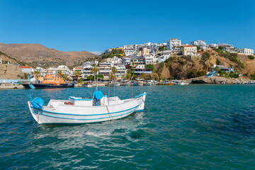 View across the harbor to the promenade and the fishing boats of the popular resort of Agia Galini...