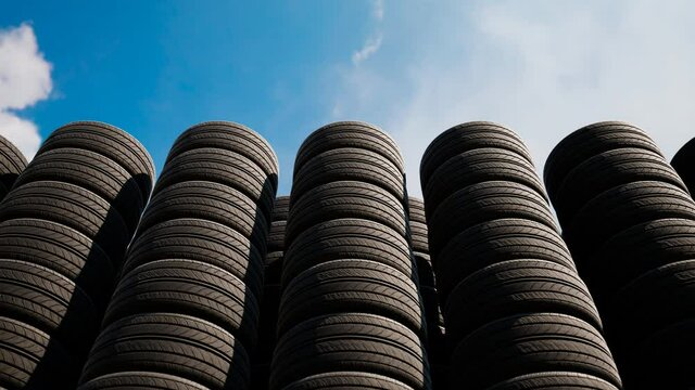 Stacks of car wheels. Black rubber tires. Tire store. Wheels changing.