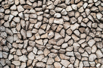 stone wall background. masonry of small natural stones.