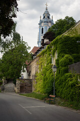 Fototapeta na wymiar Street of the old town Dürstein and the tower of the baroque Abbey above the houses, Lower Austria