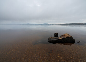 Foggy morning on the lake Lipno in the mountains Sumava, Czech Republic