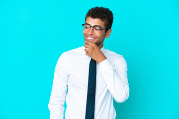 Young business Brazilian man isolated on blue background looking to the side