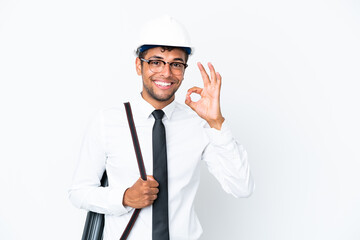 Architect brazilian man with helmet and holding blueprints showing ok sign with fingers