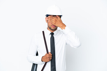 Architect brazilian man with helmet and holding blueprints covering eyes by hands. Do not want to see something