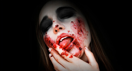 Halloween. Close up portrait bloodthirsty vampire woman Attractive sexy vampire woman with sharp teeth, fangs, blood drops.Black background, copy space.  - obrazy, fototapety, plakaty