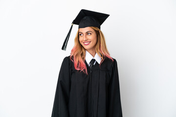 Young university graduate over isolated white background looking to the side and smiling