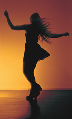Fototapeta na wymiar silhouette of a woman dancing at home