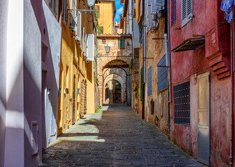 Fototapeta na wymiar Medieval narrow street in Siena, Tuscany, Italy. Architecture and landmark of Siena. Cozy cityscape of Siena
