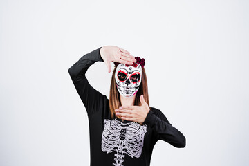 woman wearing mexican face mask during halloween celebration. skeleton costume and red roses diadem on head. Halloween party concept