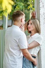 A loving guy and a girl are walking in the park. The concept of an outdoor love story.