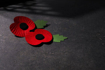 World War remembrance day. Red poppy is symbol of remembrance to those fallen in war. Red poppies on dark stone background
