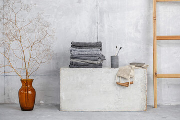 Organic waffle linen towels, bamboo toothbrushes, bathroom zero waste accessories in grey shades in contemporary bathroom interior. Daily body care, spa and wellness zero waste bathroom concept