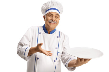 Cheerful male chef smiling and holding an empty plate