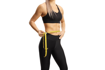 Female torso in sportswear measuring waste line