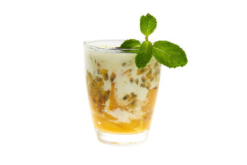 glass of healthy tropical fruit superfood shake with mango, passion fruitc coconut milk and chia seeds decorated with mint isolated at white background. Vegan diet