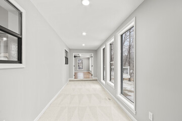 Luxury mansion sun room with snowy windows and carpet