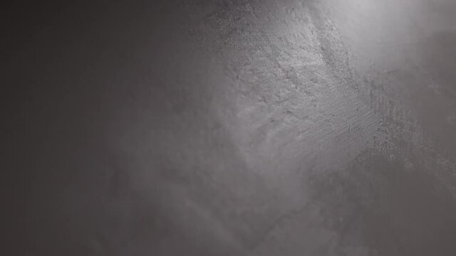 Slow motion handheld shot of decorative white plaster wall background