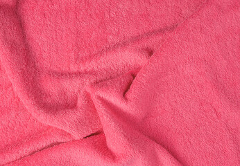 Fototapeta na wymiar Background from a pink terry towel close-up.