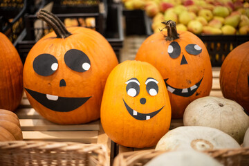 Pumpkin faces on the store counter, Halloween.