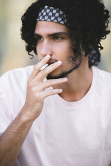 Fototapeta na wymiar Guy smoking a thoughtful cigarette