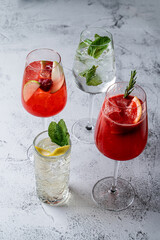Assorted summer alcoholic cocktails, bar menu photo on textured light grey background