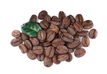 Pile of roasted coffee beans with fresh leaf on white background, top view