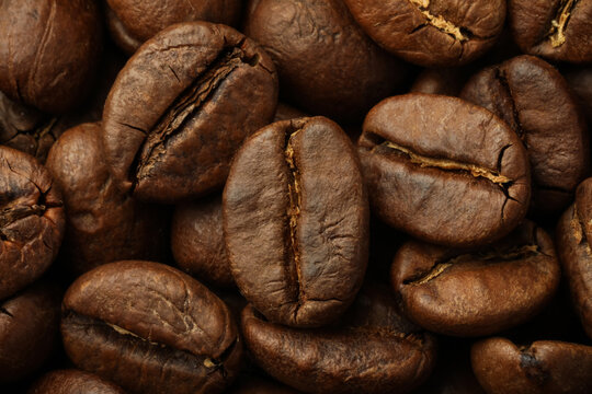 Pile of roasted coffee beans as background, closeup