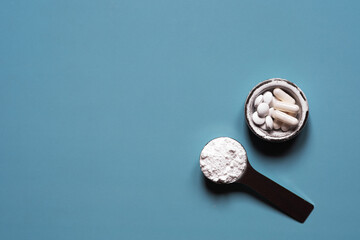 Collagen powder in a spoon and in a cup in the form of tablets and capsules. The concept of health....