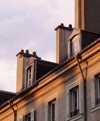 old house with chimneys in the town at sunset