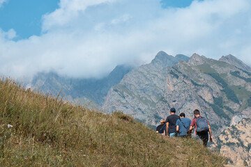 Naklejka na ściany i meble mountain landscape, a group of tourists goes to the mountains, travel, hiking, summer