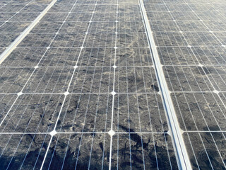 Blue modern energy saving dusty solar panel to generate electricity from the sun. Concept:...