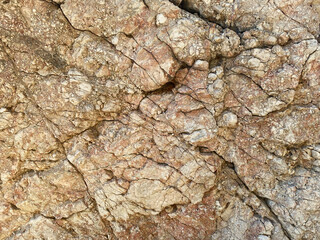 Texture of stone natural rock yellow background with cracks