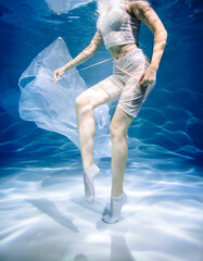 Women's health concept. Girl underwater in white. lightness, freshness and health