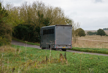 large executive grey coach-built horse transport lorry in motion across Salisbury Plain, Wiltshire...