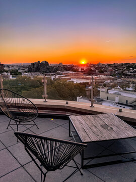 Table and chairs from a Brooklyn Rooftop overlooking Gowan's and the Hudson River at sunset 