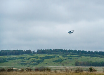 British Royal Navy AgustaWestland Merlin HM.2 AW101 helicopter on a military exercise over Wiltshire UK, low grey cloud