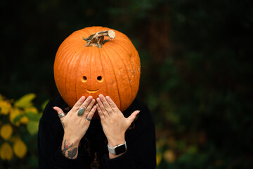 person with a pumpkin face 
