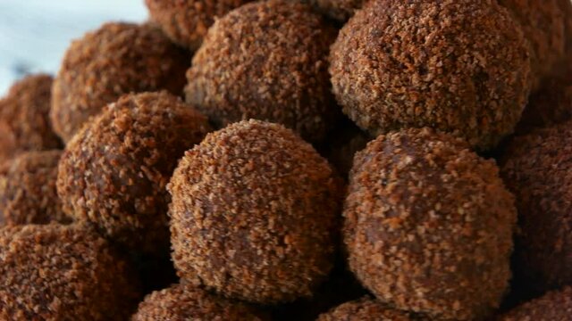 candies coated in chocolate cocoa and biscuit sweet brown balls close up